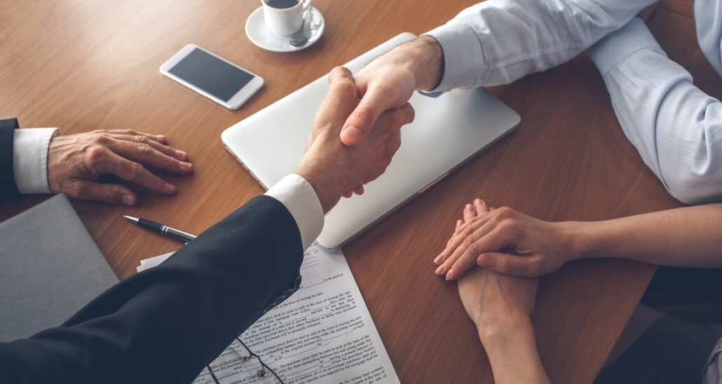 photo of real estate agent and inspector shaking hands